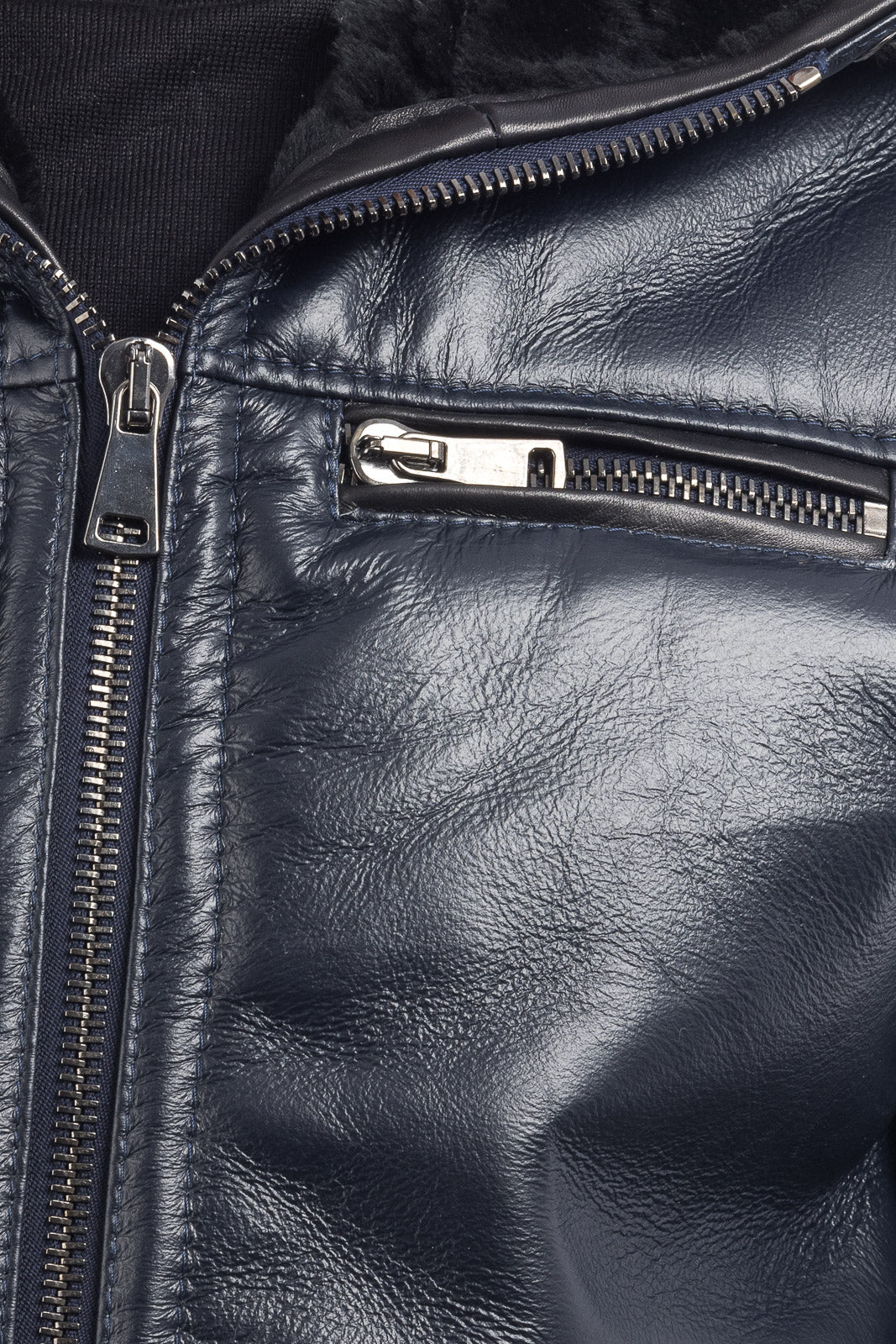 Bomber interamente in montone blu pelo nero con zip e cappuccio